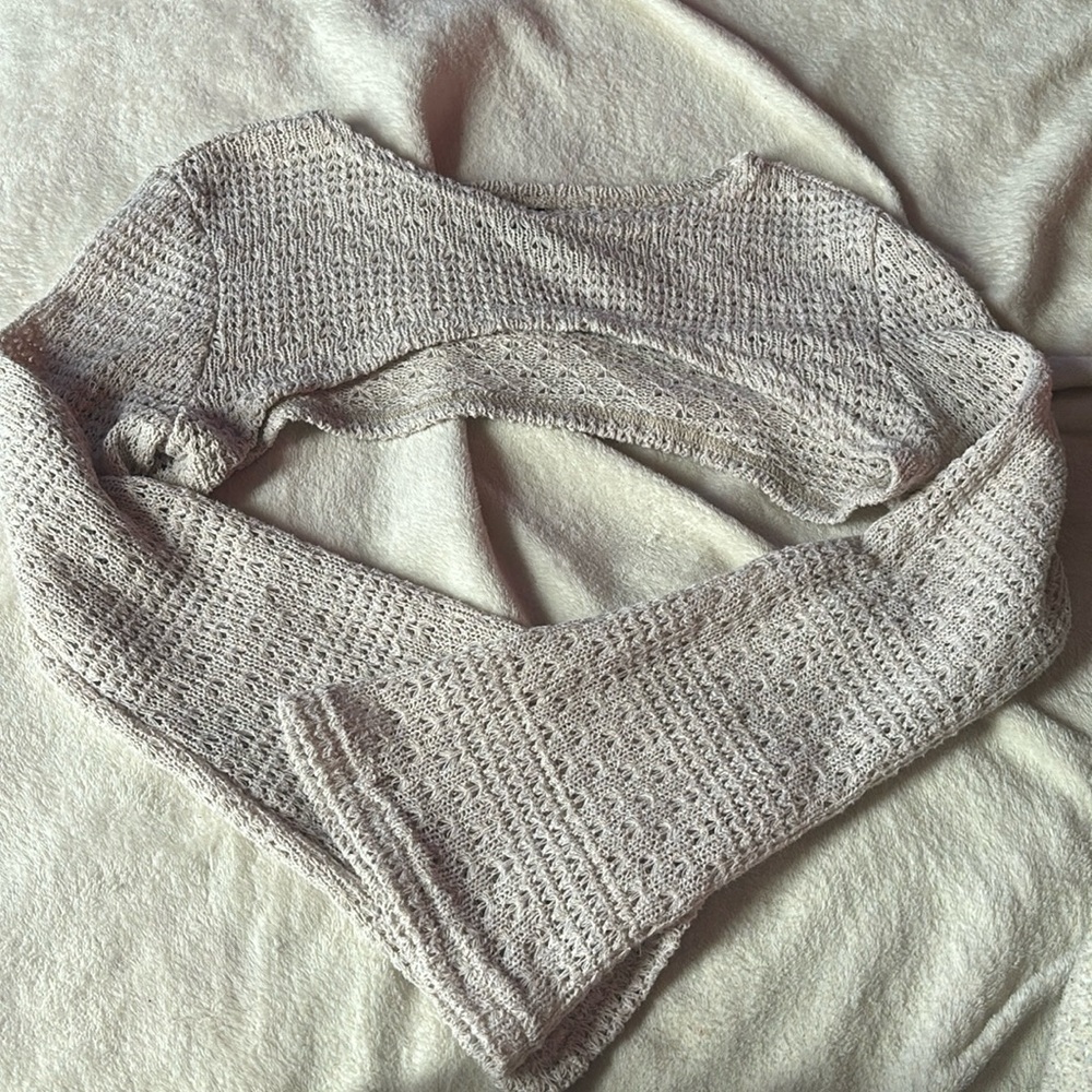 Crochet sleeve cover. Off white color. knitted material.